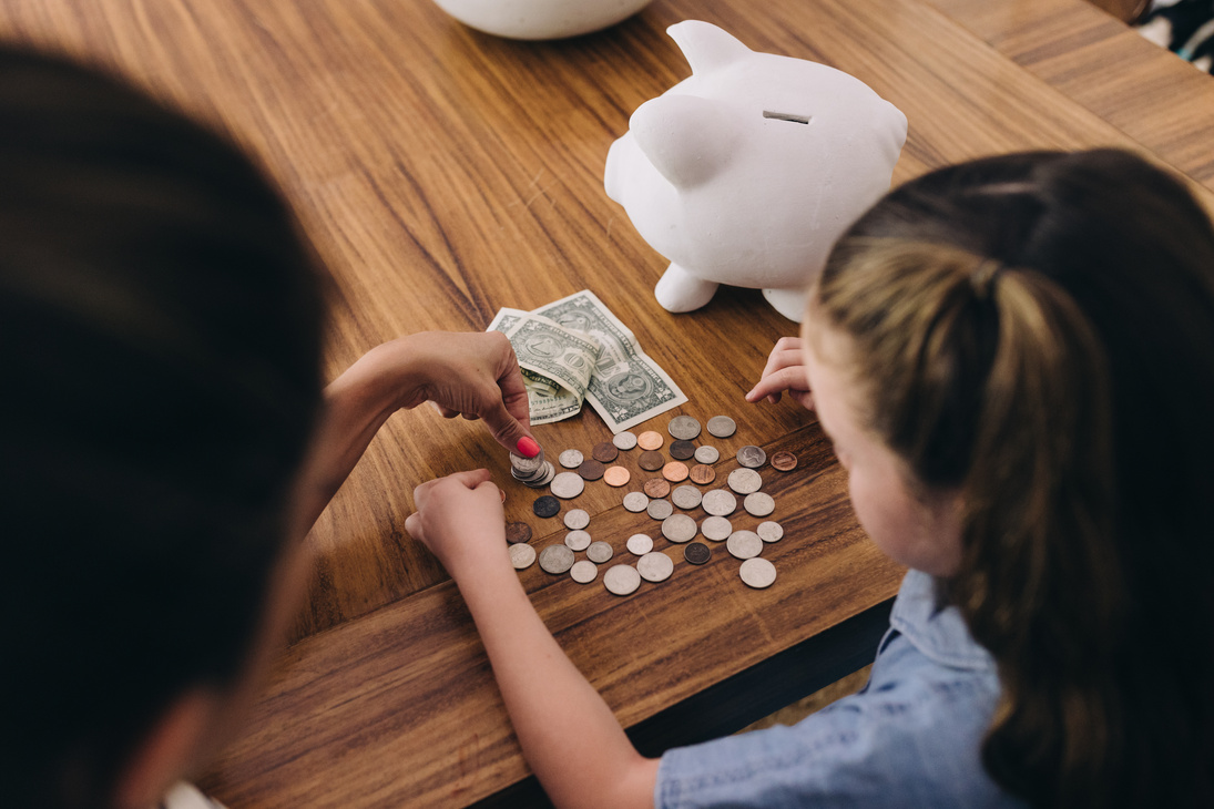 Children Counting Money from Piggy Bank 